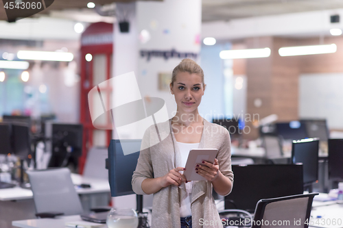 Image of Business Woman Using Digital Tablet in front of startup Office