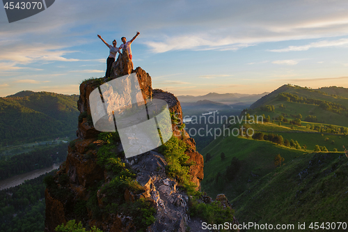 Image of Happy man and woman on top mountain