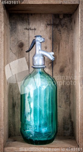 Image of vintage turquoise soda glass bottle