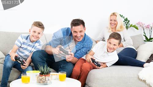 Image of Happy young family playing videogame On TV.