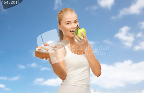 Image of happy woman eating apple instead of cake