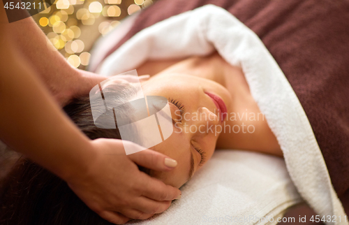 Image of woman having head massage at spa