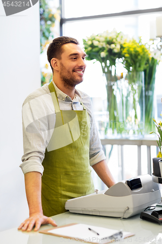 Image of florist man or seller at flower shop counter