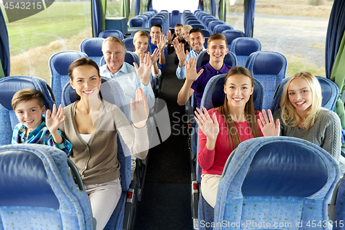 Image of group of happy passengers travelling by bus