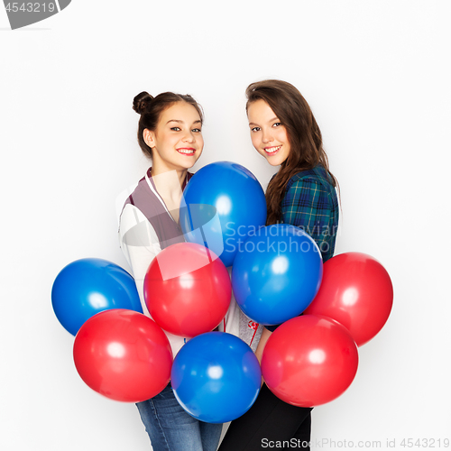 Image of happy teenage girls with helium balloons