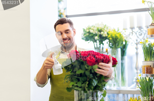 Image of florist or seller setting red roses at flower shop