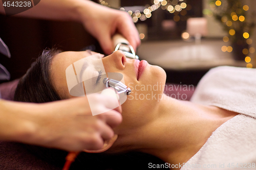 Image of woman having hydradermie facial treatment in spa