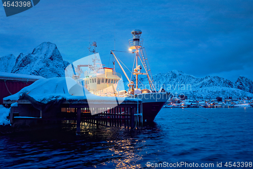 Image of Fishing boat in Reine village at night. Lofoten islands, Norway