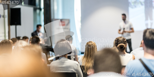 Image of Male business speaker giving a talk at business conference event.