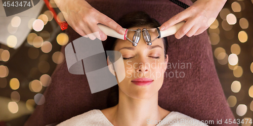 Image of woman having hydradermie facial treatment in spa