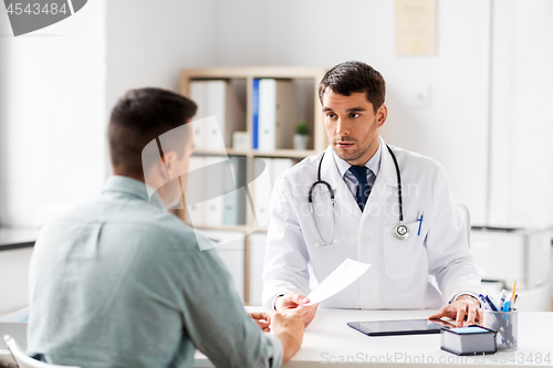 Image of doctor giving prescription to patient at hospital