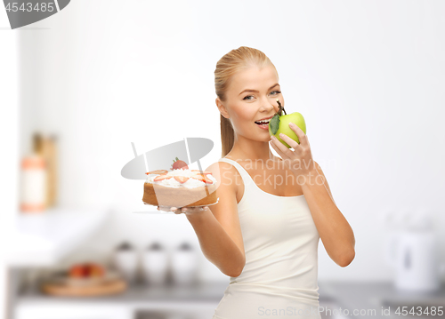 Image of happy woman eating apple instead of cake