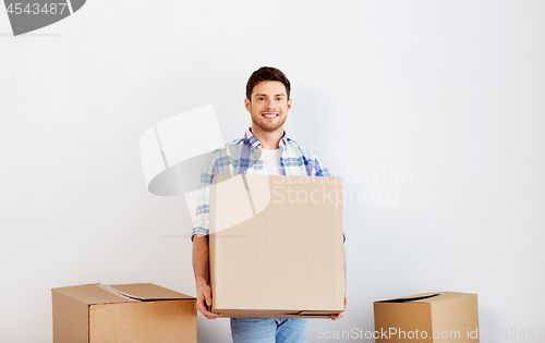 Image of happy man with cardboard box moving to new home