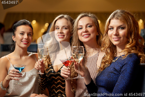 Image of happy women drinks in glasses at night club