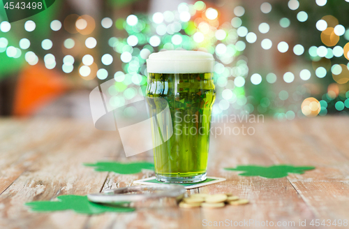 Image of glass of green beer, horseshoe and golden coins