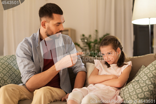 Image of upset or feeling guilty girl and father at home