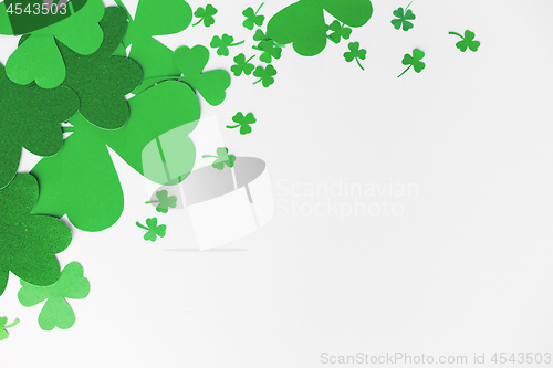 Image of green paper shamrocks on white background