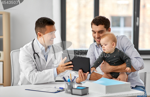 Image of father with baby and doctor with tablet at clinic