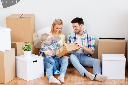 Image of happy family with boxes moving to new home