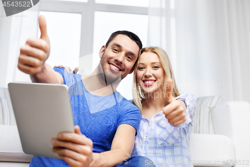 Image of couple with tablet computer showing thumbs up