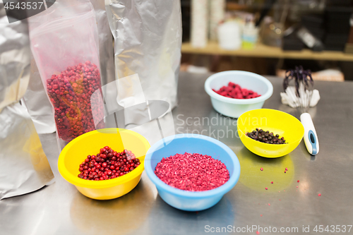 Image of berries in bowls at confectionery shop kitchen