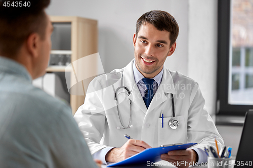 Image of doctor with clipboard and male patient at hospital