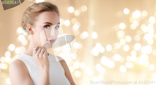 Image of woman in white dress with diamond jewelry