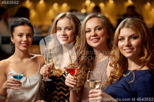 Image of happy women drinks in glasses at night club