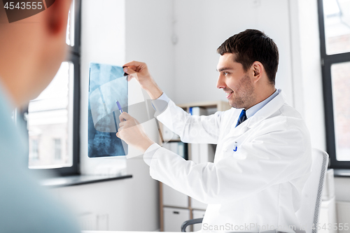 Image of doctor showing x-ray to patient at hospital