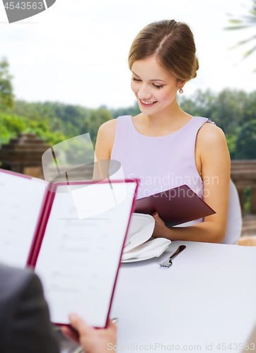 Image of couple with menus at restaurant