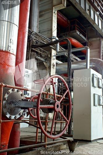 Image of Pipes, tubes, machinery and steam turbine at a power plant