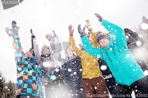 Image of group of young people throwing snow in the air