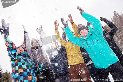 Image of group of young people throwing snow in the air