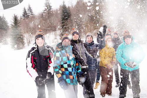 Image of group of young people throwing snow in the air