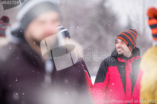 Image of portrait of young man in beautiful winter landscape