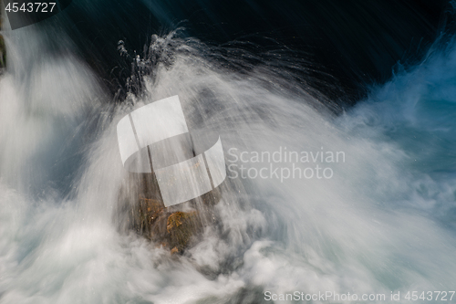 Image of single stone in wild river