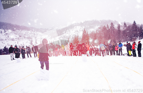 Image of group of young people having a running in bag competition