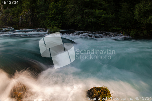 Image of single stone in wild river