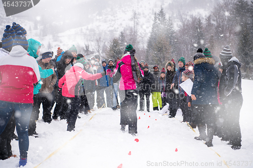 Image of group of young people having blindfolded games competition