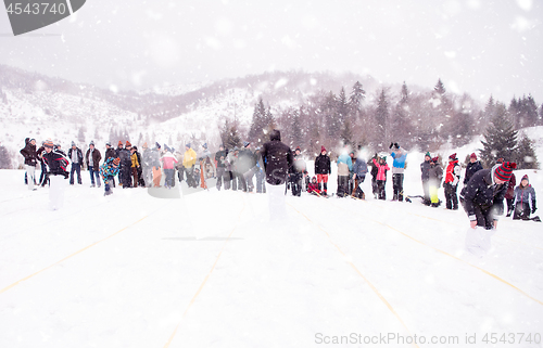 Image of group of young people having a running in bag competition