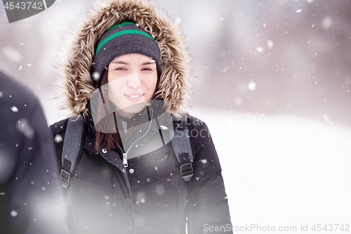 Image of Portrait of young woman on snowy winter day