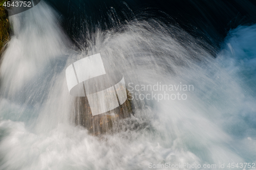 Image of single stone in wild river