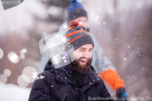 Image of portrait of young man in beautiful winter landscape