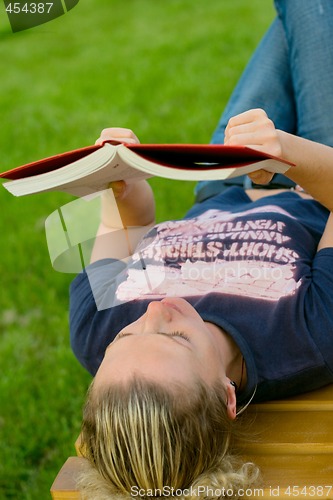 Image of woman reading in the park