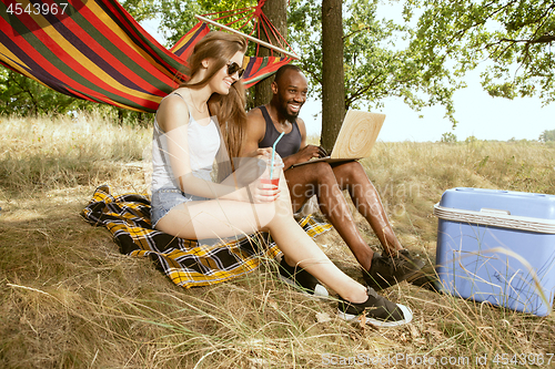 Image of Young multiethnic international couple outdoors