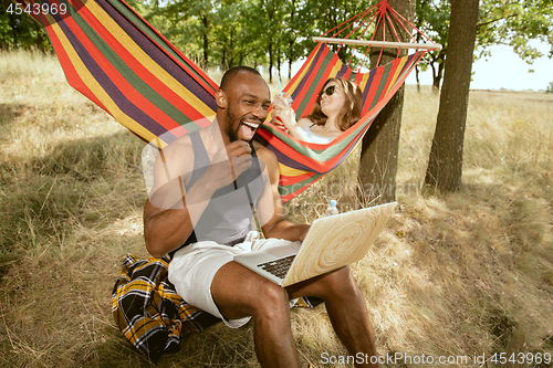 Image of Young multiethnic international couple outdoors