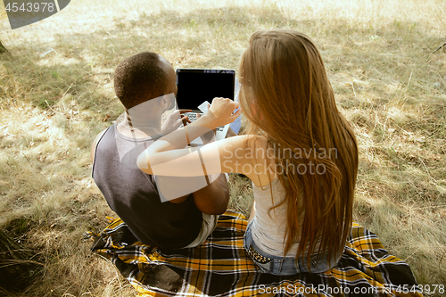 Image of Young multiethnic international couple outdoors