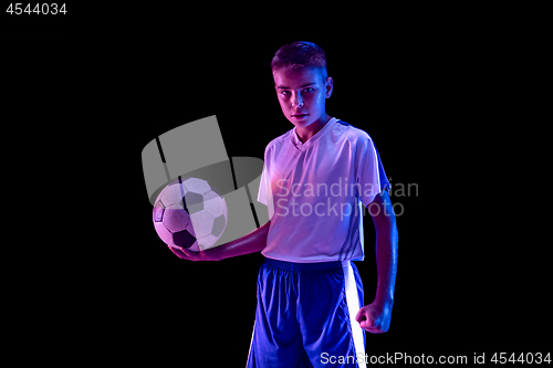 Image of Young boy as a soccer or football player on dark studio background