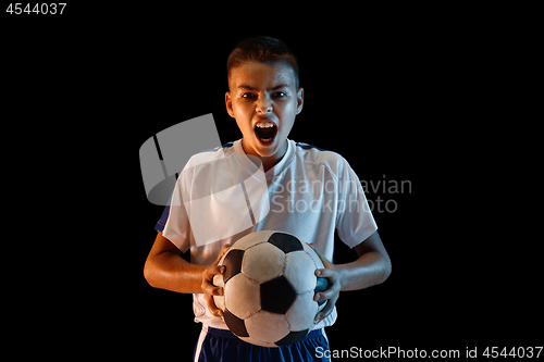 Image of Young boy as a soccer or football player on dark studio background