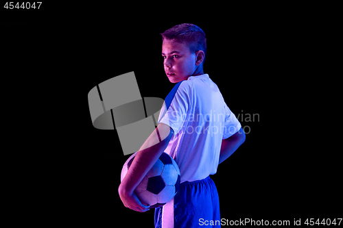 Image of Young boy as a soccer or football player on dark studio background